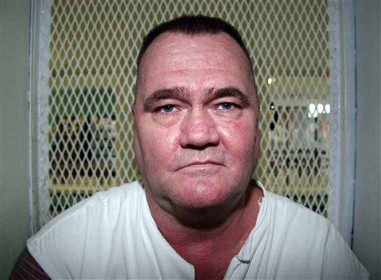 In this Aug. 29, 2012, photo, convicted killer Cleve Foster speaks from a visiting cage at the Texas Department of Criminal Justice Polunsky Unit outside Livingston, Texas. 